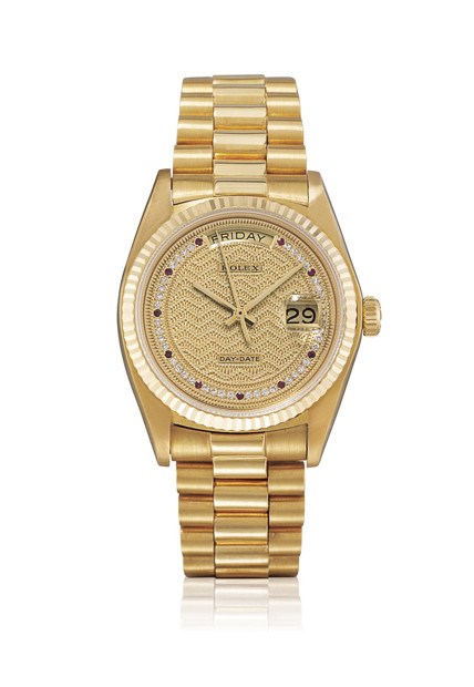 ROLEX, "DAY-DATE" REF. 18038

18K GOLD, DIAMOND AND RUBY-SET SELF-WINDING BRACELET WATCH WITH SWEEP SECONDS, DAY AND DATE DISPLAY