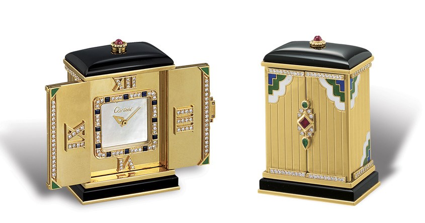 CARTIER, PENDULETTE EN CADRAN DEPLOYANT

18K GOLD, MULTI-GEMS, AND ENAMEL-SET MINIATURE RECTANGULAR DESK CLOCK WITH MOTHER-OF-PEARL DIAL