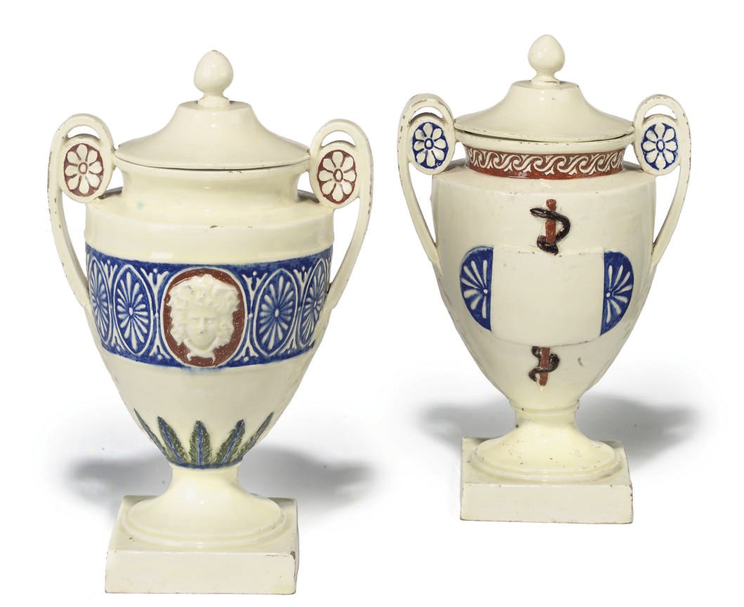 A PAIR OF ITALIAN MAIOLICA TWO HANDLED JARS AND COVERS