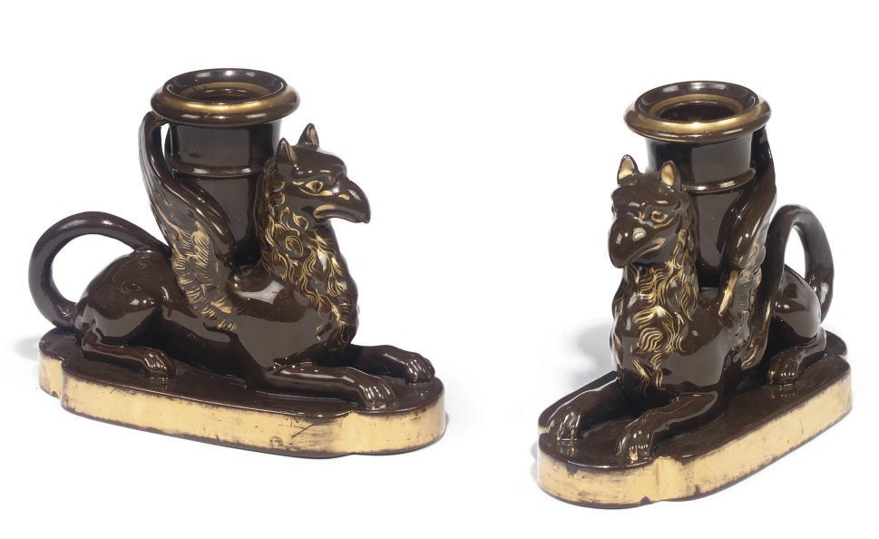 A PAIR OF STAFFORDSHIRE BROWN-GLAZED CANDLESTICKS
