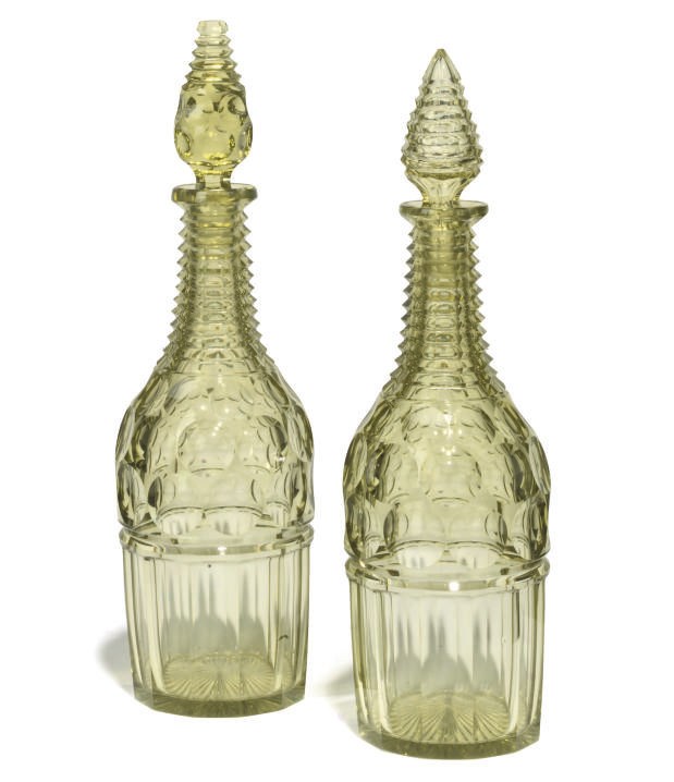 A PAIR OF URANIUM GREEN GLASS DECANTERS AND STOPPERS
