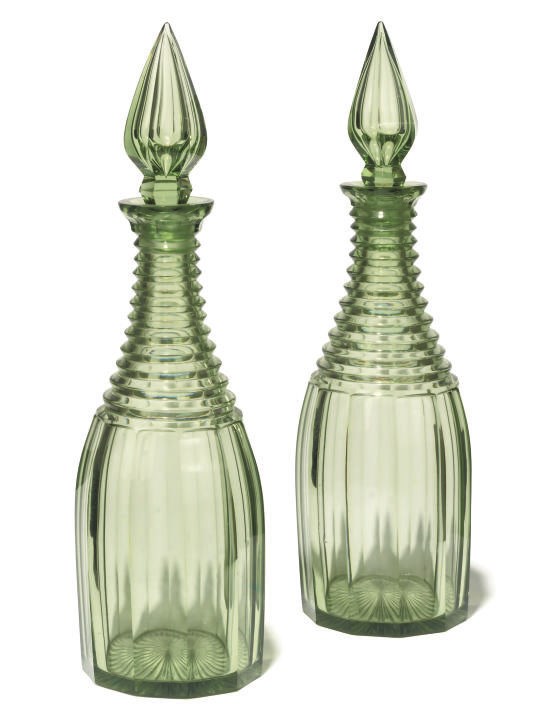 A PAIR OF ENGLISH GREEN-TINTED GLASS DECANTERS AND STOPPERS