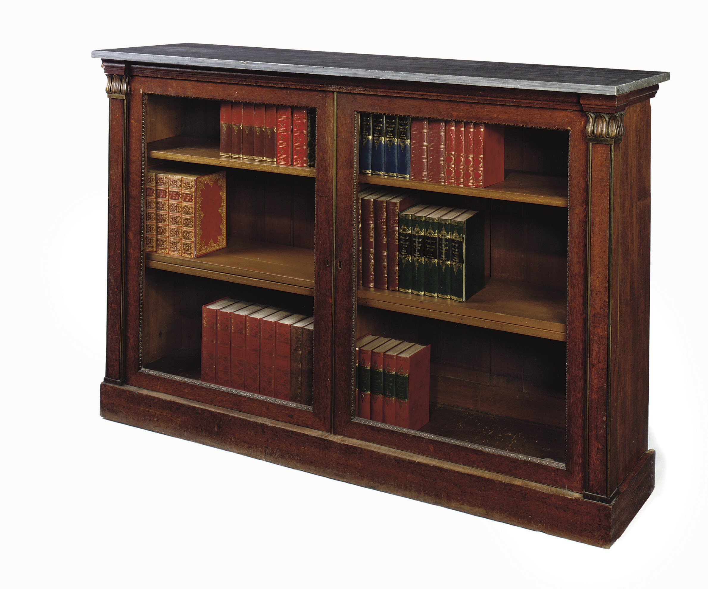 A REGENCY ORMOLU-MOUNTED OAK BOOKCASE