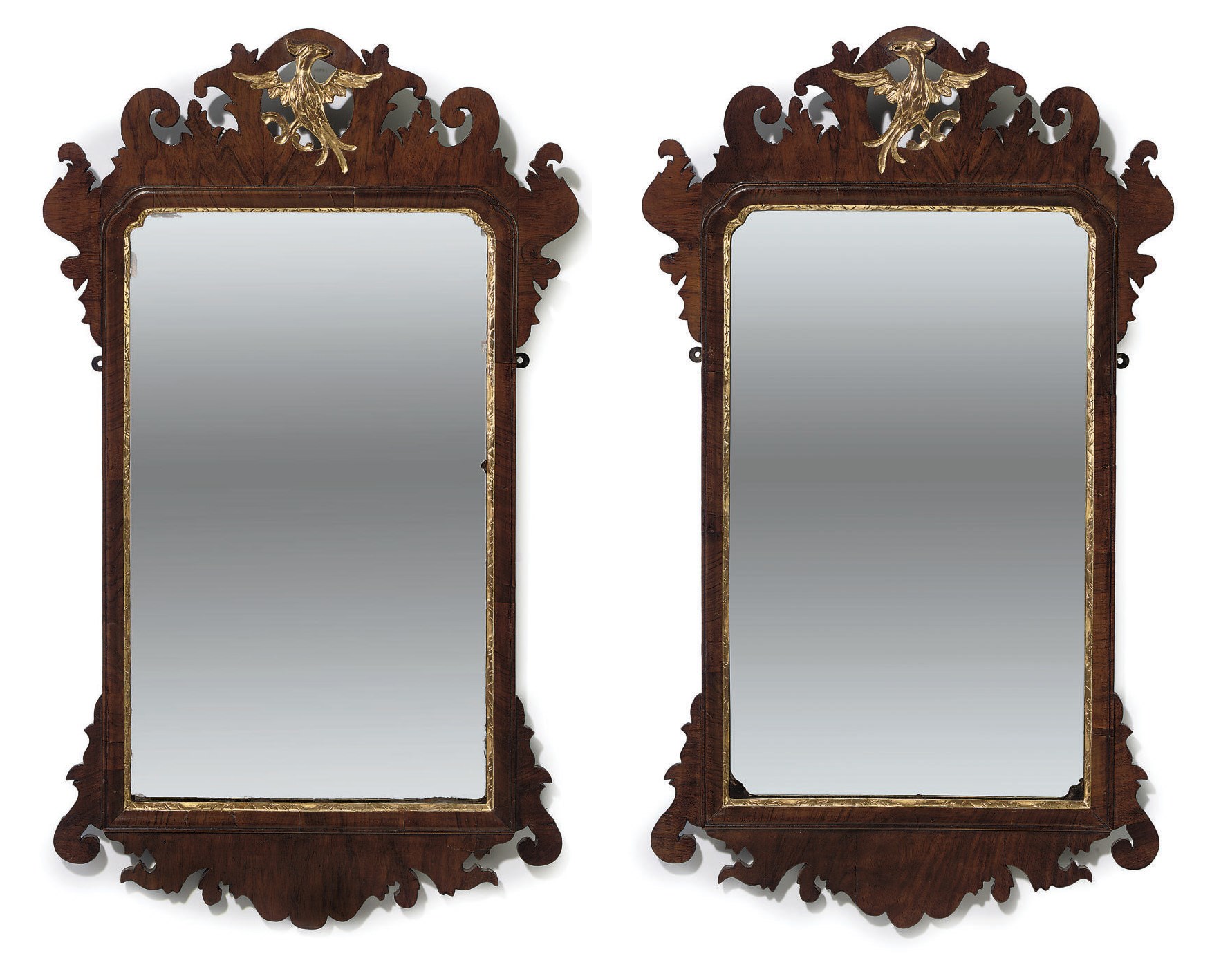 A PAIR OF PARCEL-GILT AND WALNUT MIRRORS