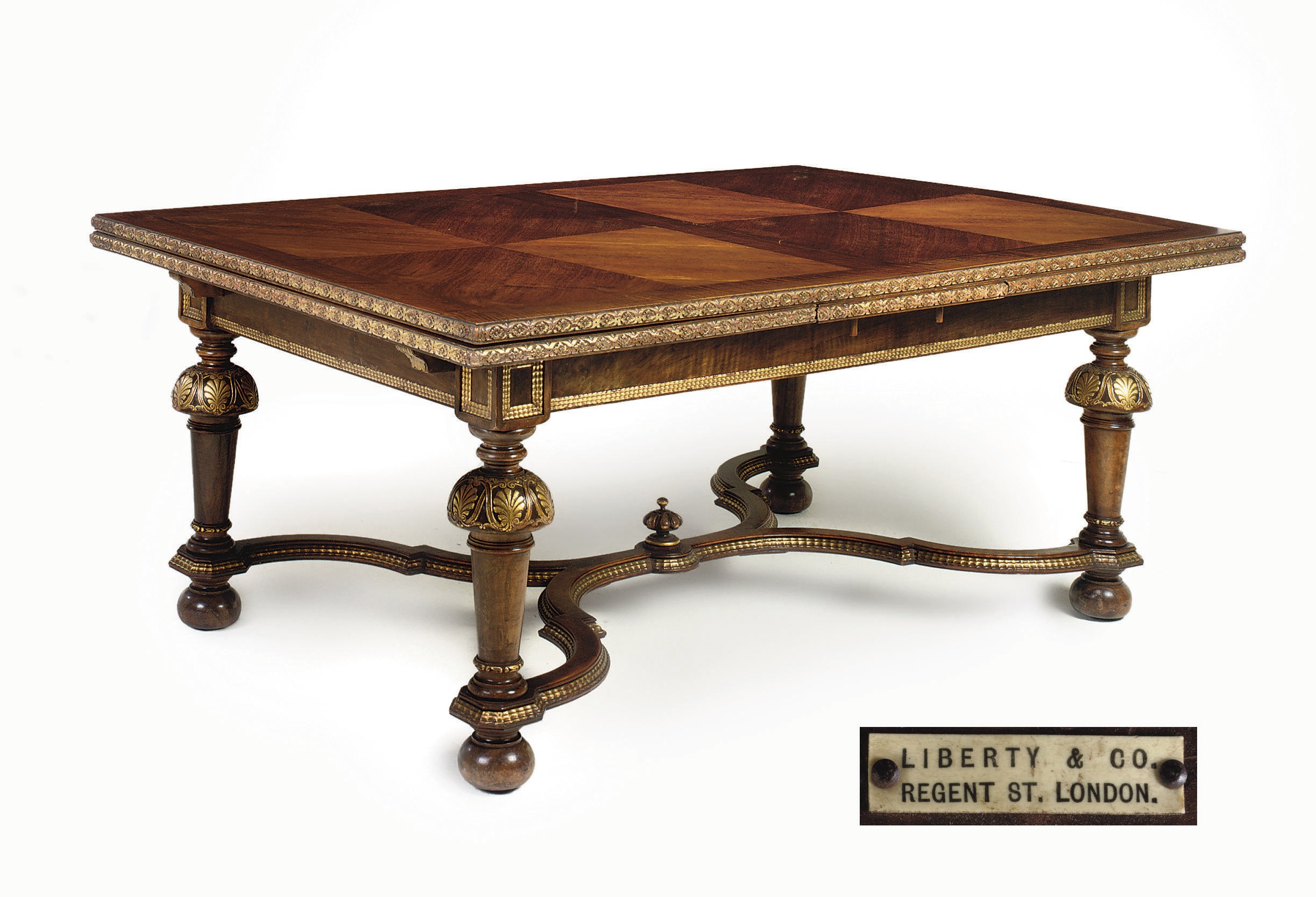 A 'WILLIAM AND MARY STYLE' PARCEL-GILT AND WALNUT DRAW-LEAF DINING TABLE