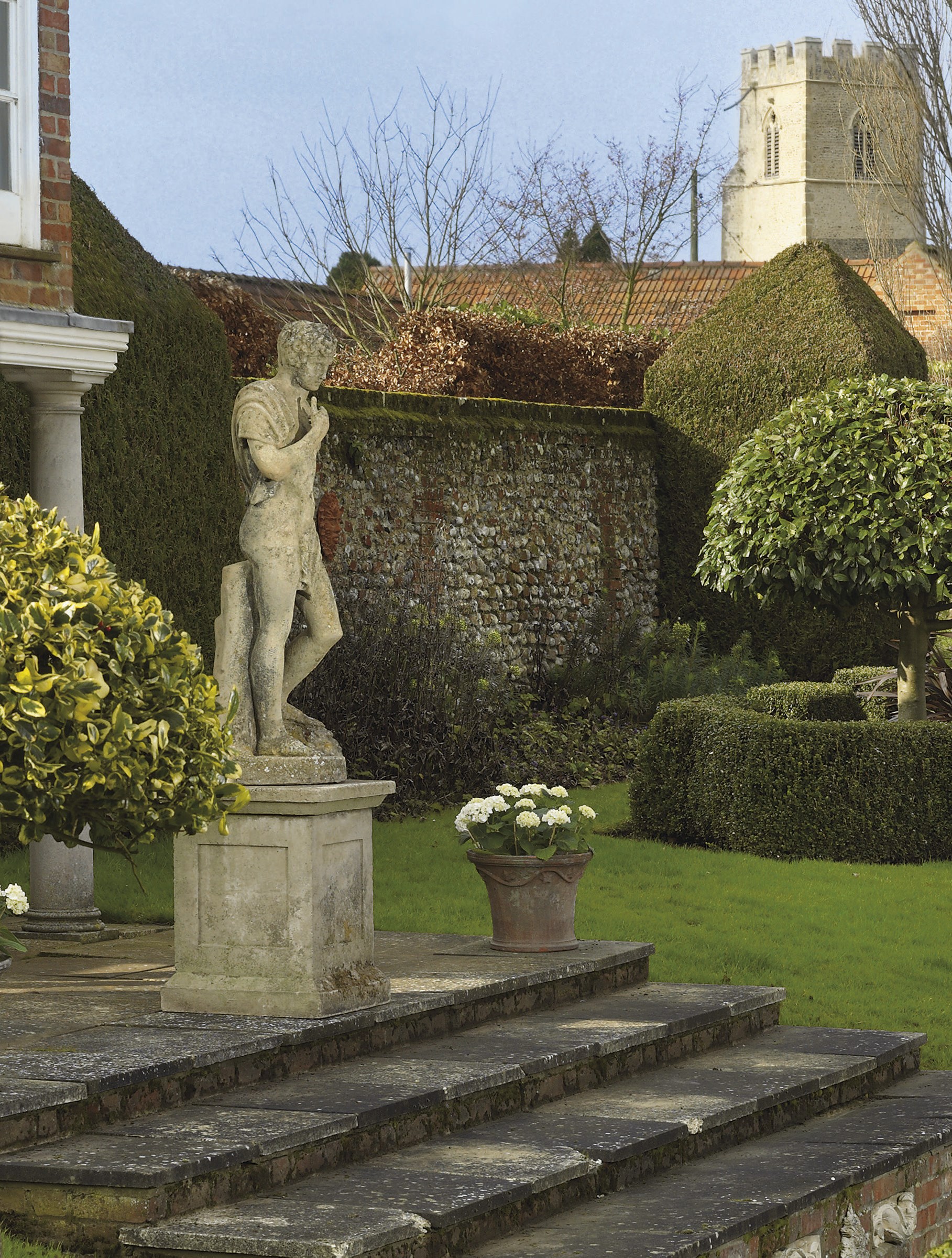 A RECONSTITUTED STONE FIGURE OF APOLLO