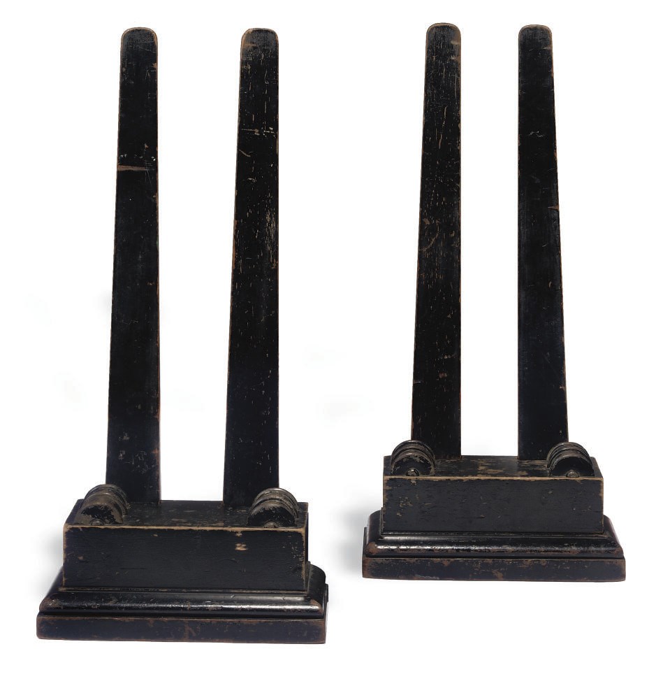 A PAIR OF VICTORIAN EBONISED MAHOGANY PLATE STANDS