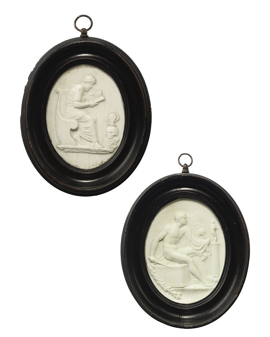 A PAIR OF OVAL COMPOSITION PASTE PLAQUES