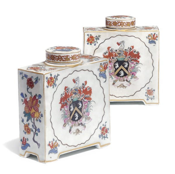A PAIR OF CONTINENTAL PORCELAIN ARMORIAL TEA-CADDIES AND COVERS