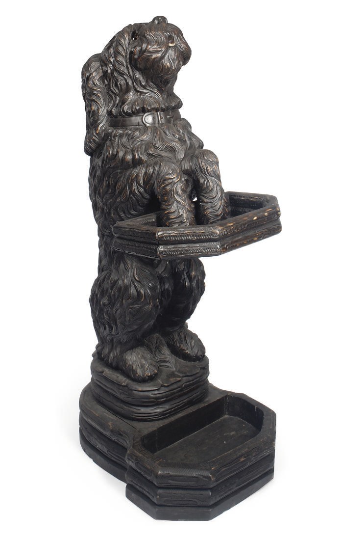 A SOUTH GERMAN STICK-STAND CARVED AS A BEGGING TERRIER