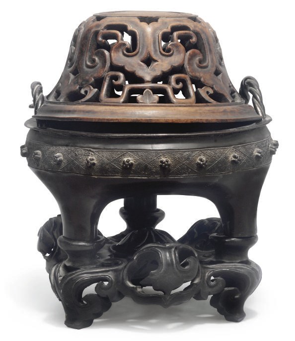 A Chinese bronze tripod censer and cover