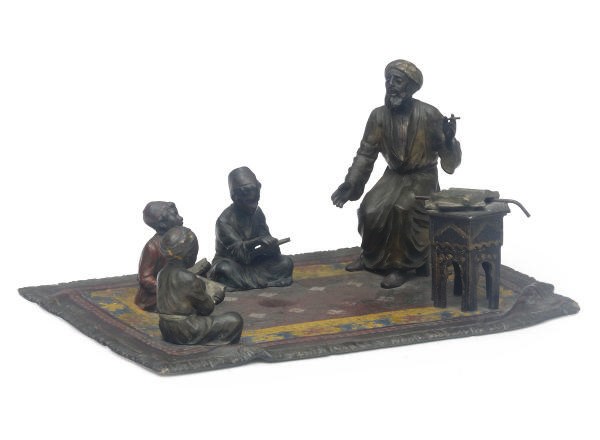 A AUSTRIAN COLD-PAINTED BRONZE GROUP OF A TEACHER AND THREE PUPILS