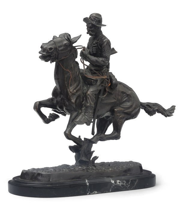 A BRONZE OF A COWBOY ON HORSEBACK