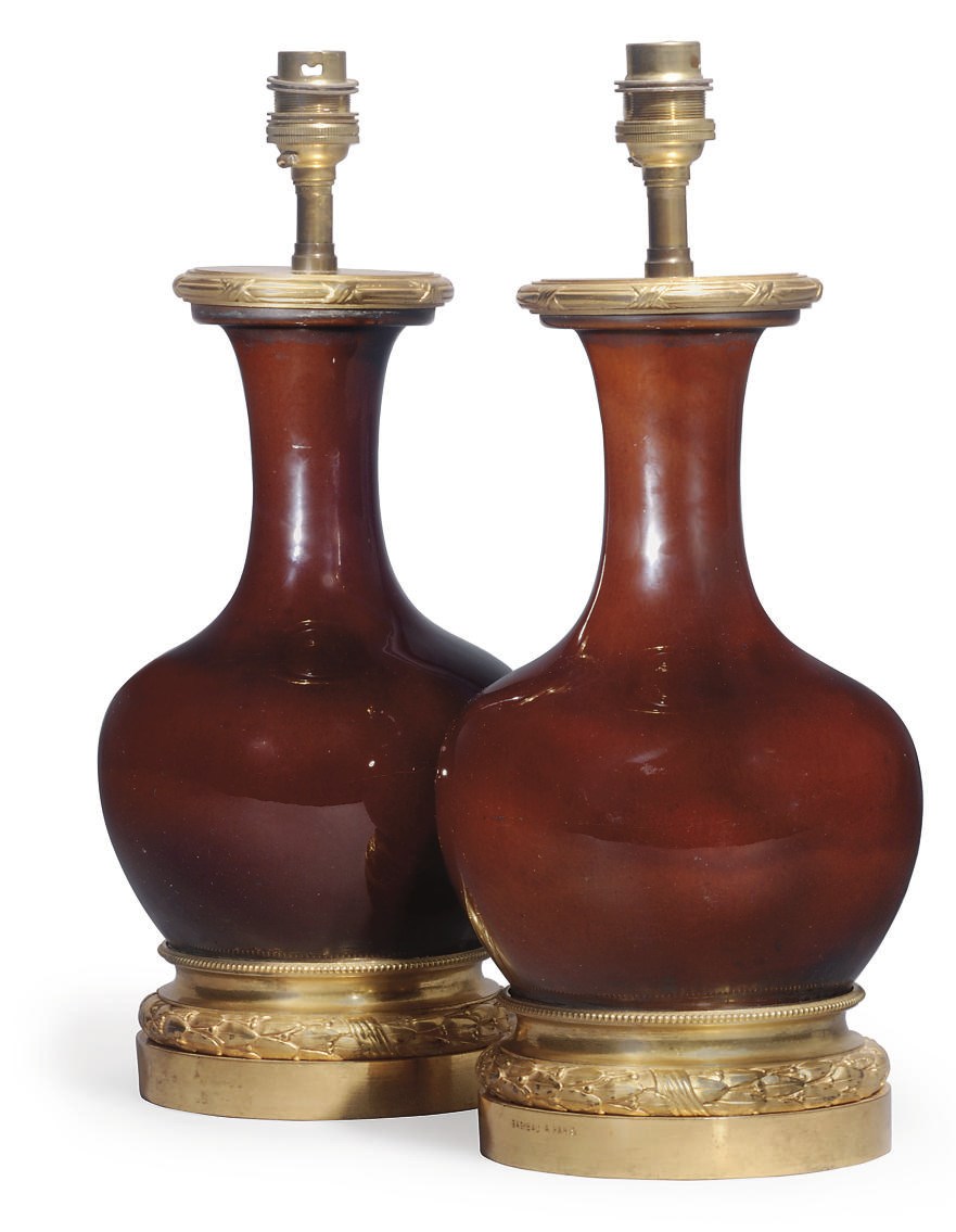 A PAIR OF CHINESE PORCELAIN SANG DE BOEUF AND GILT-BRONZE MOUNTED LAMPS