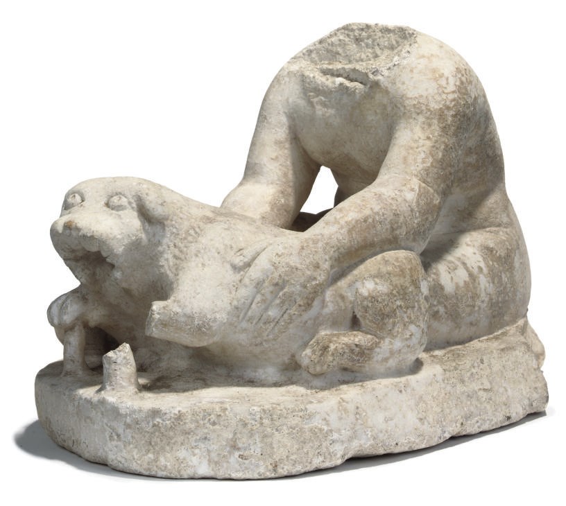 AN ACEPHALOUS MARBLE FIGURE OF A BOY PLAYING WITH A PUPPY