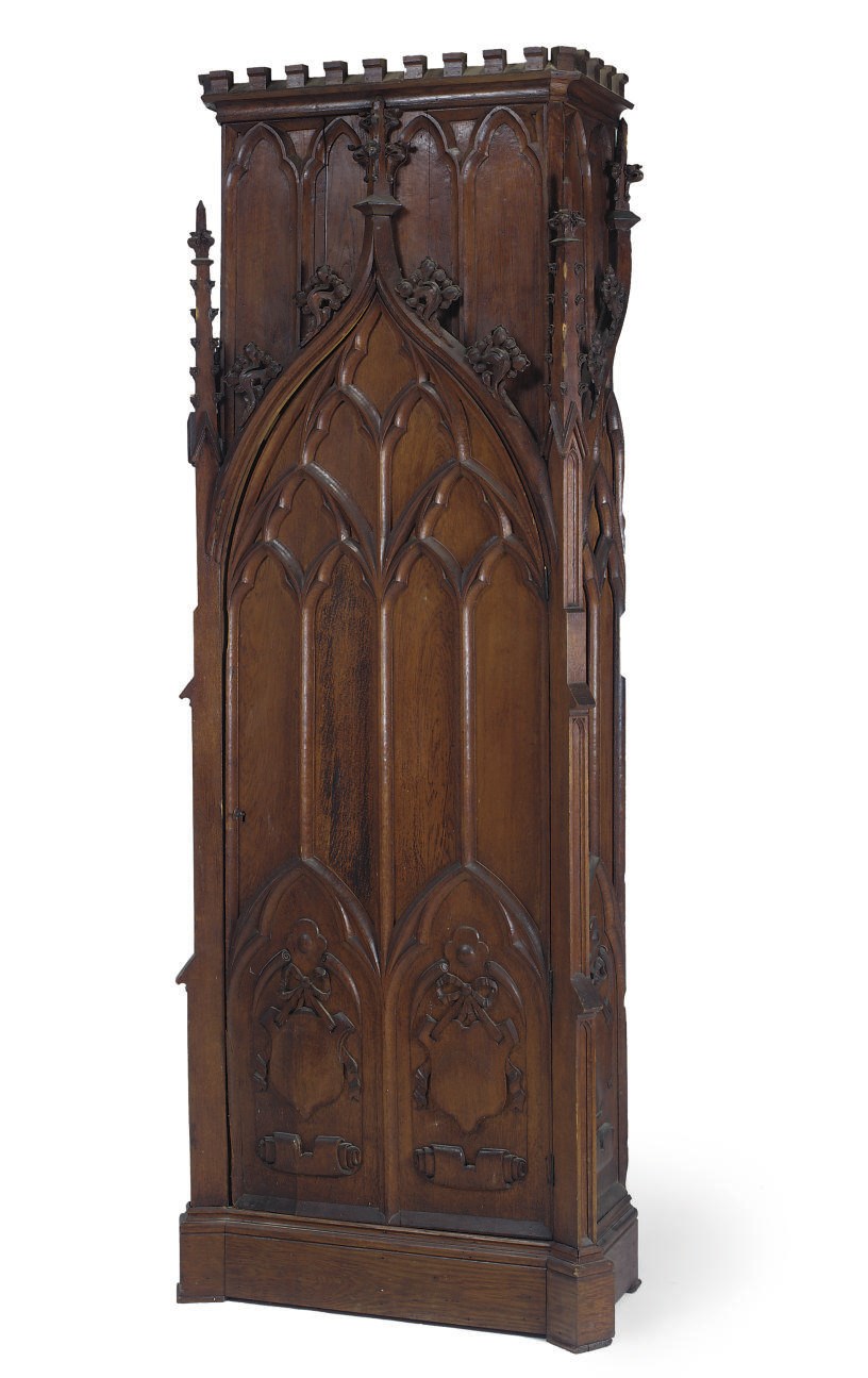 AN EARLY VICTORIAN GOTHIC CARVED OAK CUPBOARD