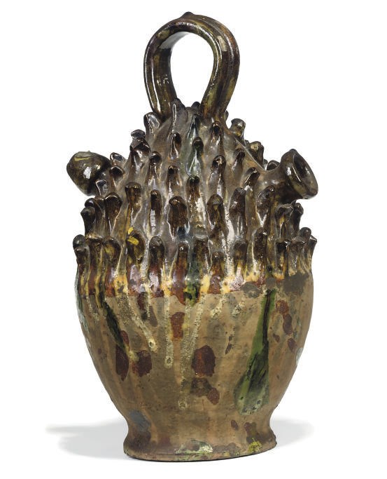 A SPANISH POTTERY 'HEDGEHOG' EWER
