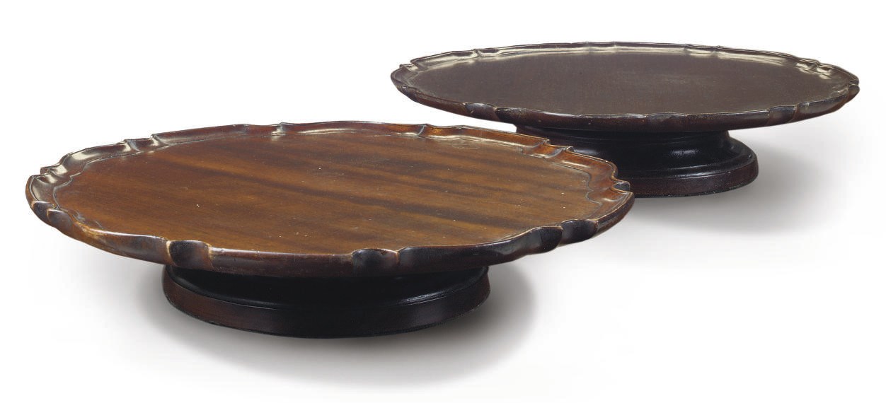 A NEAR PAIR OF MAHOGANY PIE CRUST LAZY SUSANS