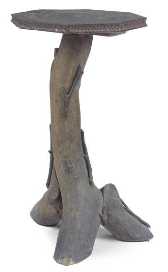 A RUSTIC TREE TRUNK OCCASIONAL TABLE