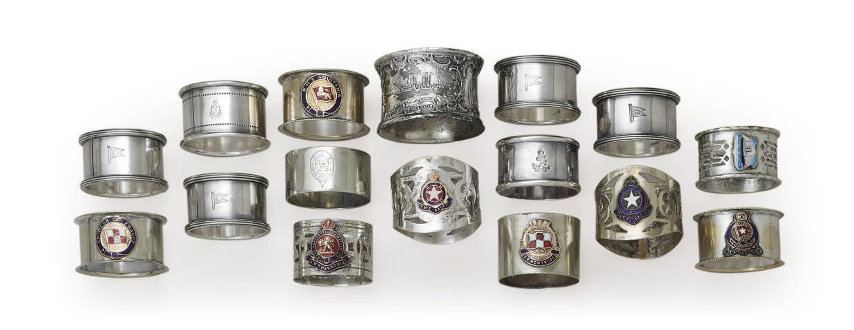 A group of silver and enamel napkin rings for various ships
