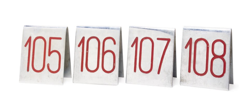 A set of four chrome and enamel table numbers for the S.S. France