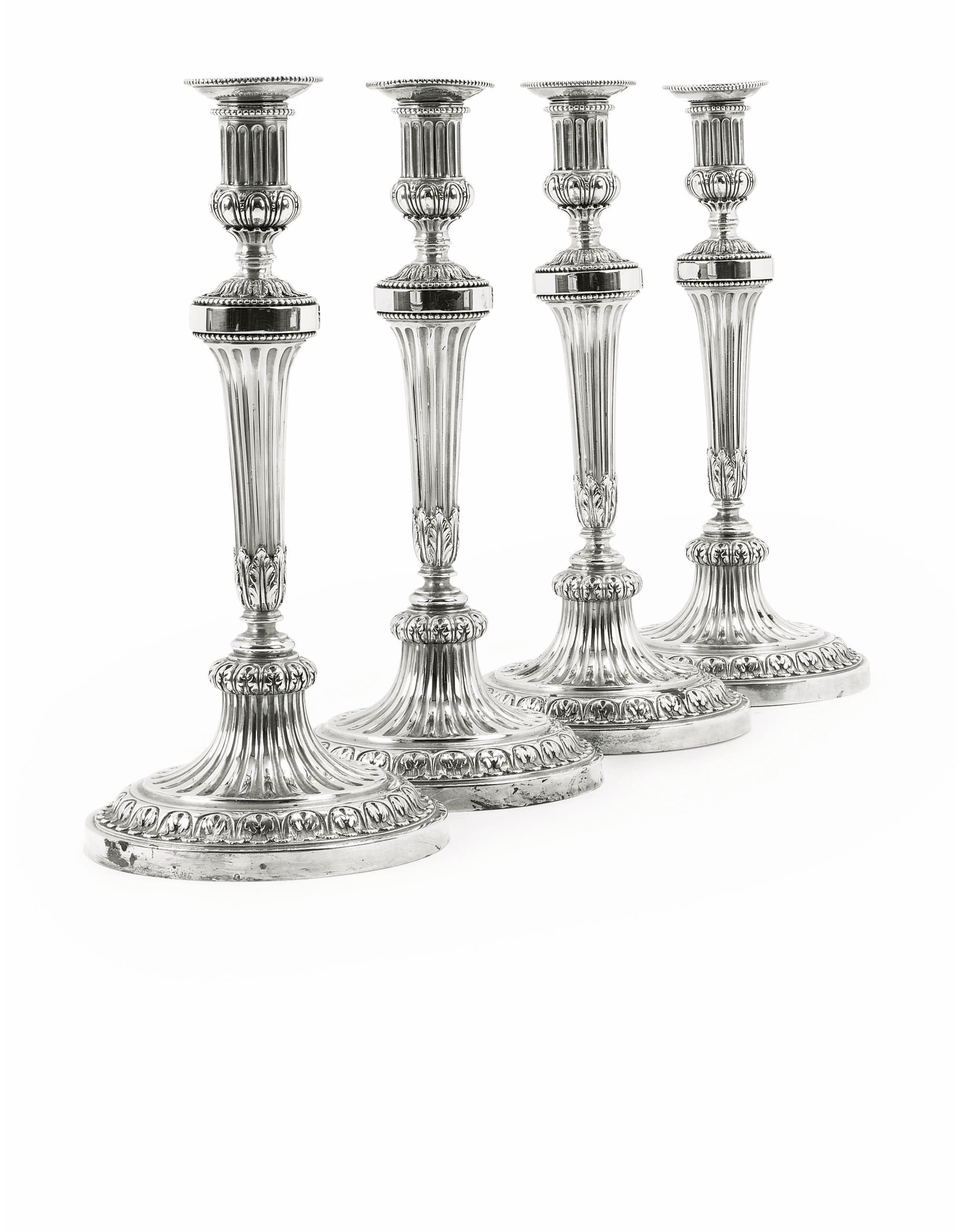 A SET OF FOUR DUTCH CANDLESTICKS