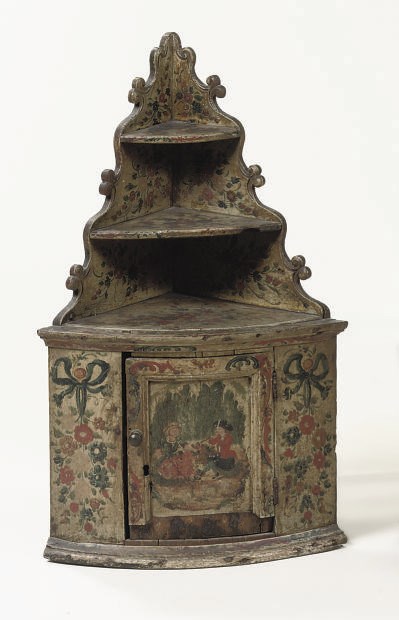 A HANGING CORNER CUPBOARD
