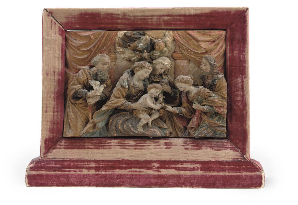 A POLYCHROME CARVED LIMEWOOD RELIEF OF THE HOLY FAMILY