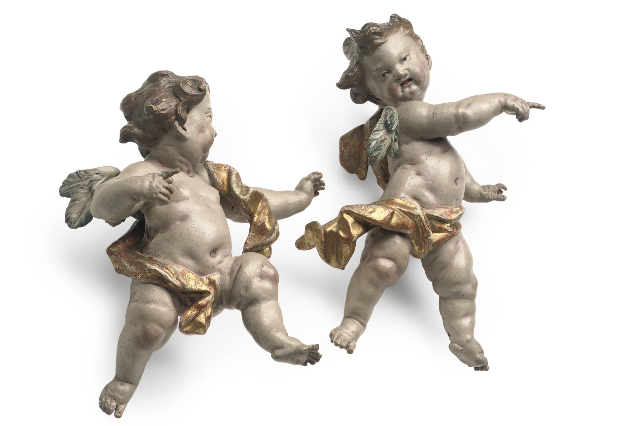 A PAIR OF SOUTH GERMAN POLYCHROME DECORATED AND PARCEL-GILT CARVED WOOD PUTTI