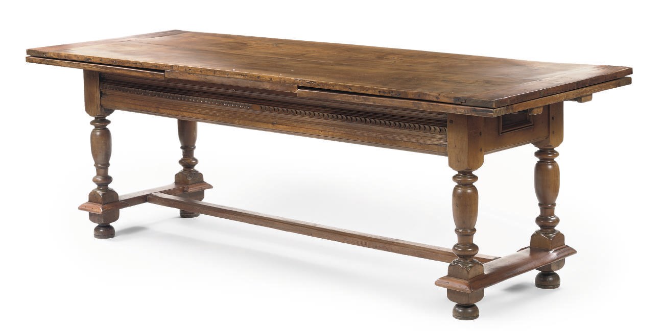 A NORTH EUROPEAN WALNUT AND FRUITWOOD AND PINE DRAW-LEAF TABLE