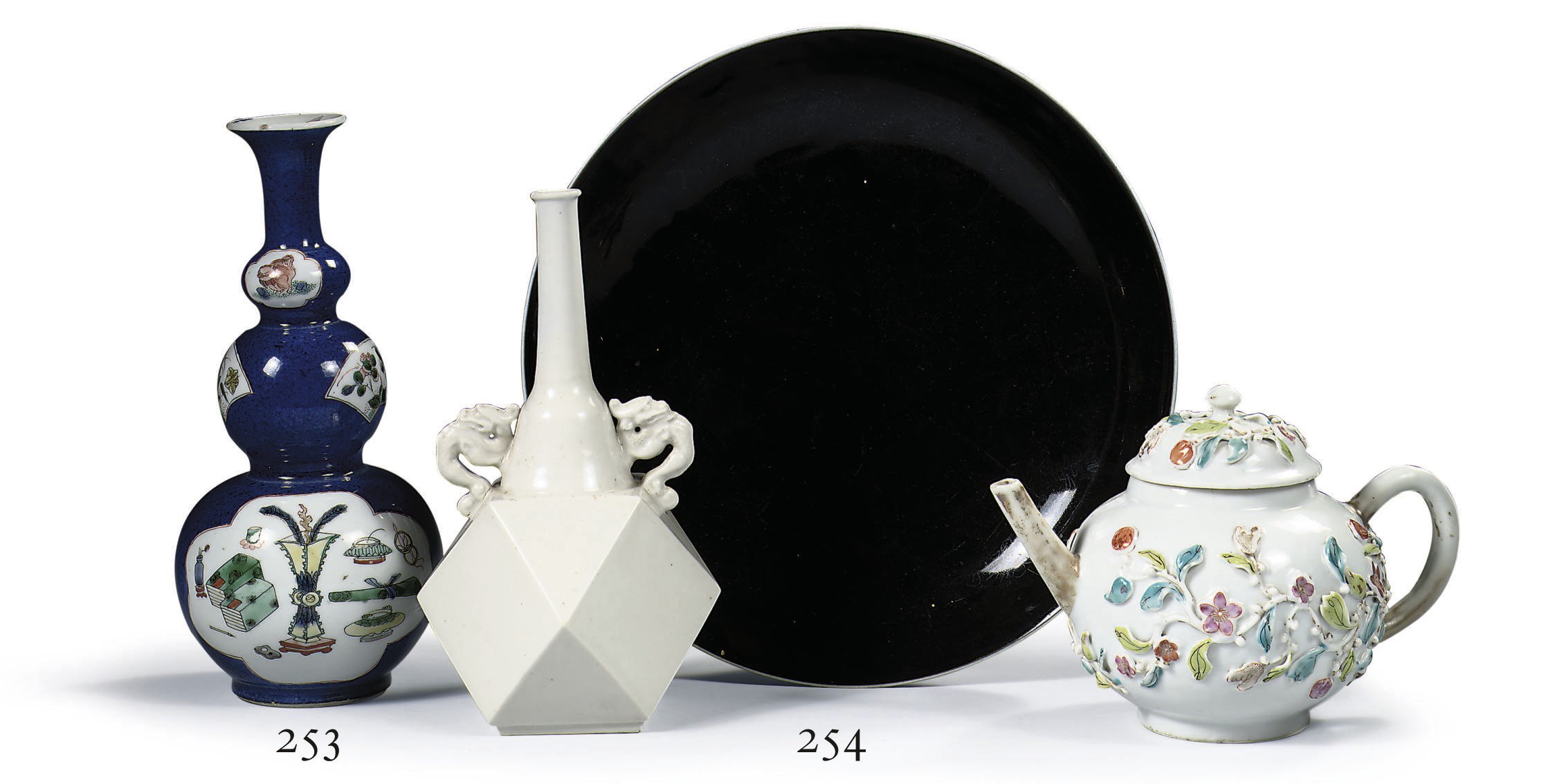 A Chinese famille rose teapot and cover, a Chinese white-glazed vase and a Chinese black-glazed dish