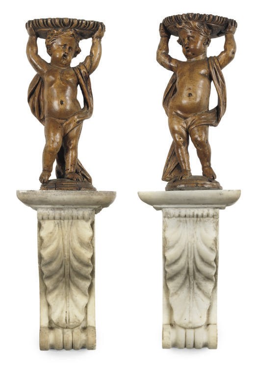 A PAIR OF CARVED LIMEWOOD CHERUBS