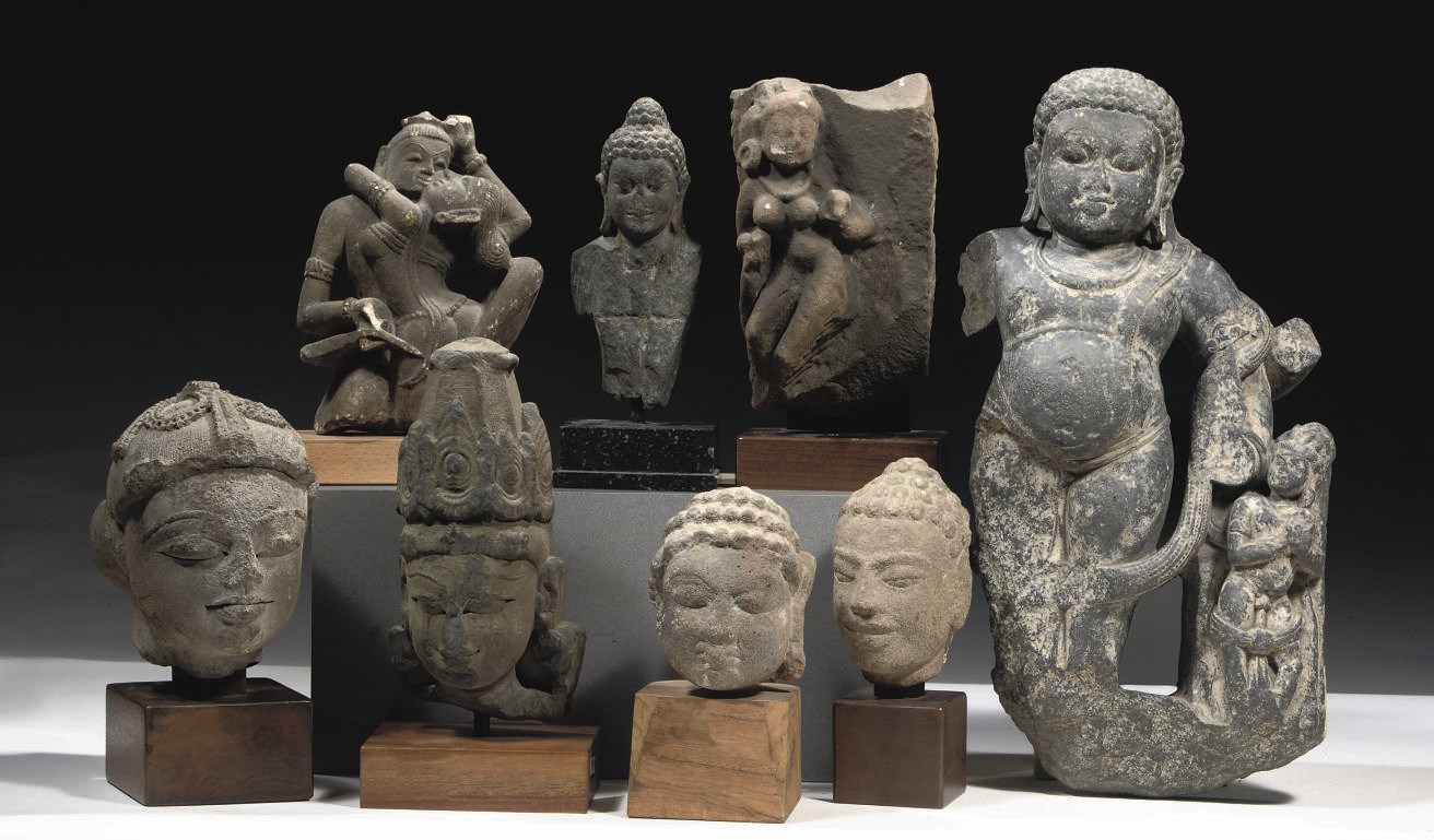 Ten Indian sandstone head fragments and seven Indian stone fragments