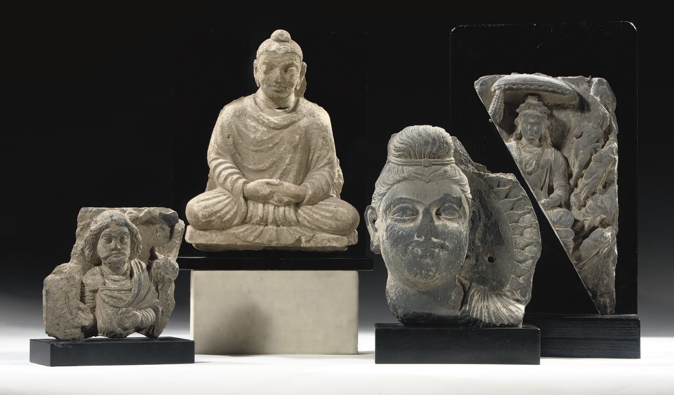 Three Gandhara grey schist fragments and a stucco figure