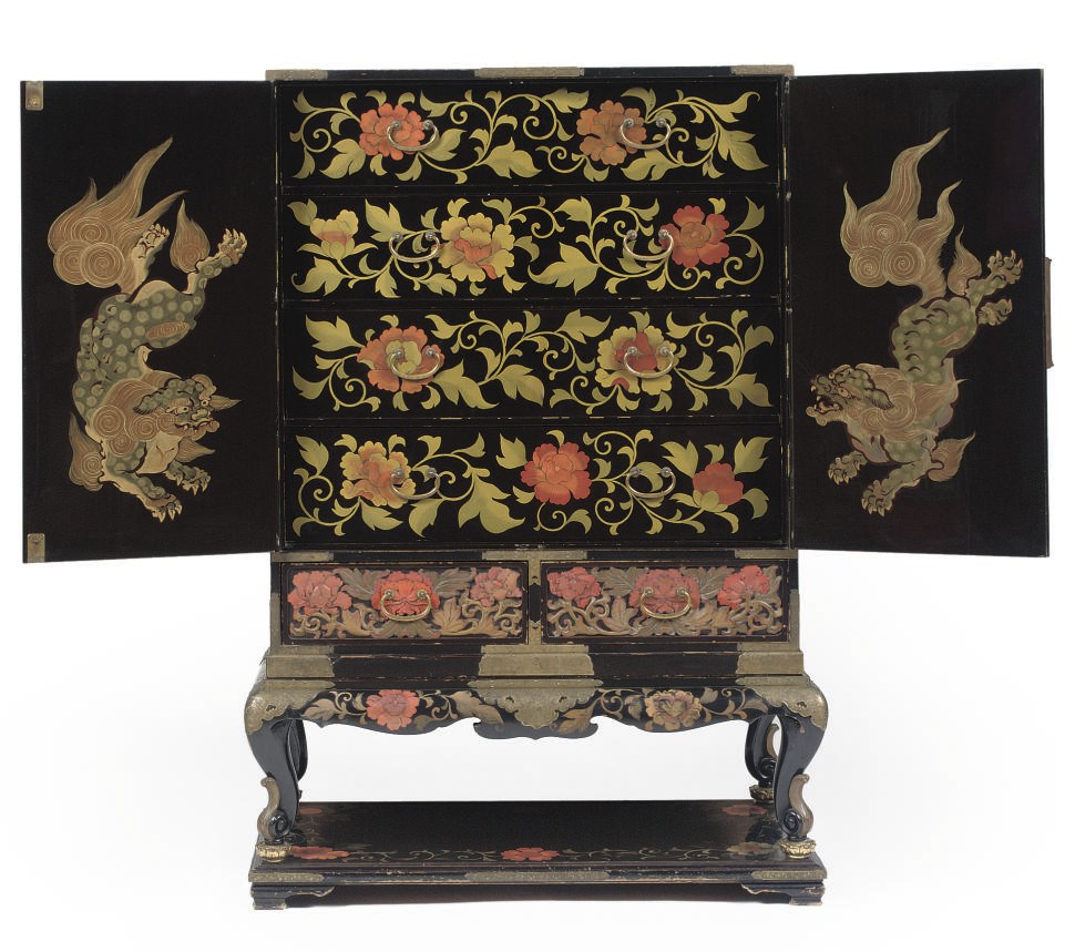 A lacquered wood cabinet on stand