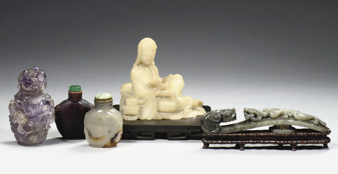 A Chinese white jade figure of Guanyin, a belthook and snuff bottles