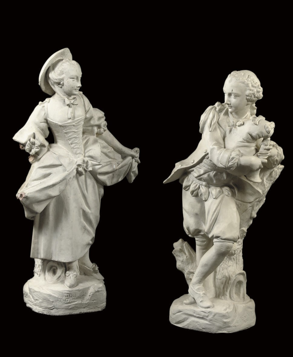 A PAIR OF WHITE PAINTED TERRACOTTA FIGURES OF A MAIDEN AND A BOY