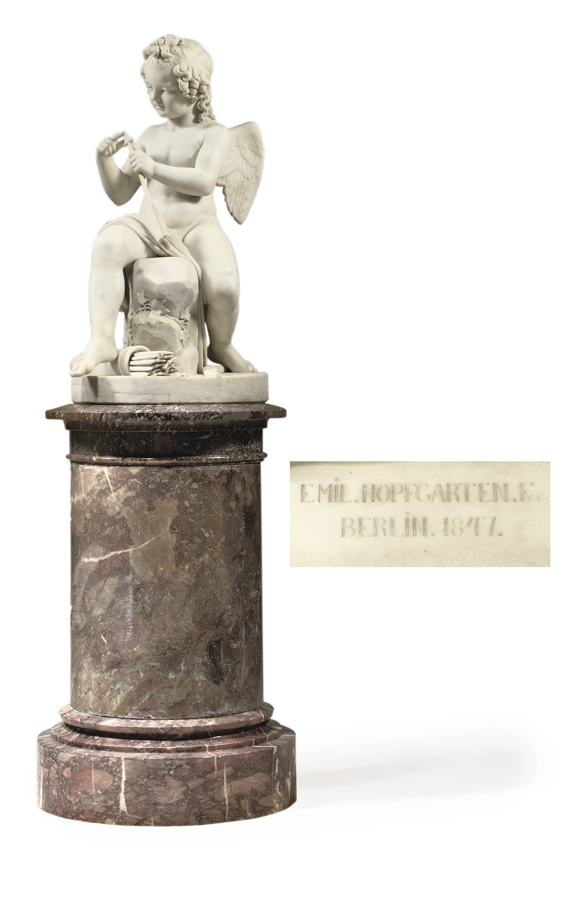 A GERMAN CARRARA MARBLE FIGURE OF CUPID SHARPENING HIS ARROW, ON 'BRECHE VIOLETTE' MARBLE PEDESTAL