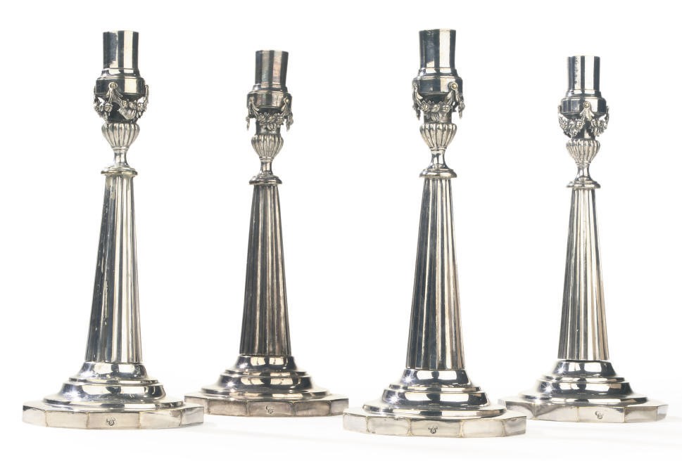 A SET OF FOUR GERMAN SILVER PLATED CANDLE STICKS