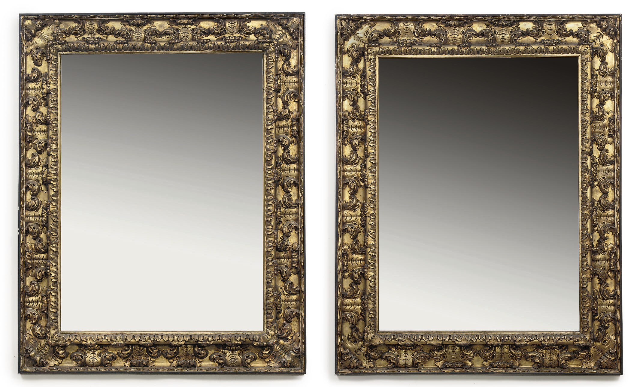 A PAIR OF AUSTRIAN GILTWOOD AND EBONISED MIRRORS