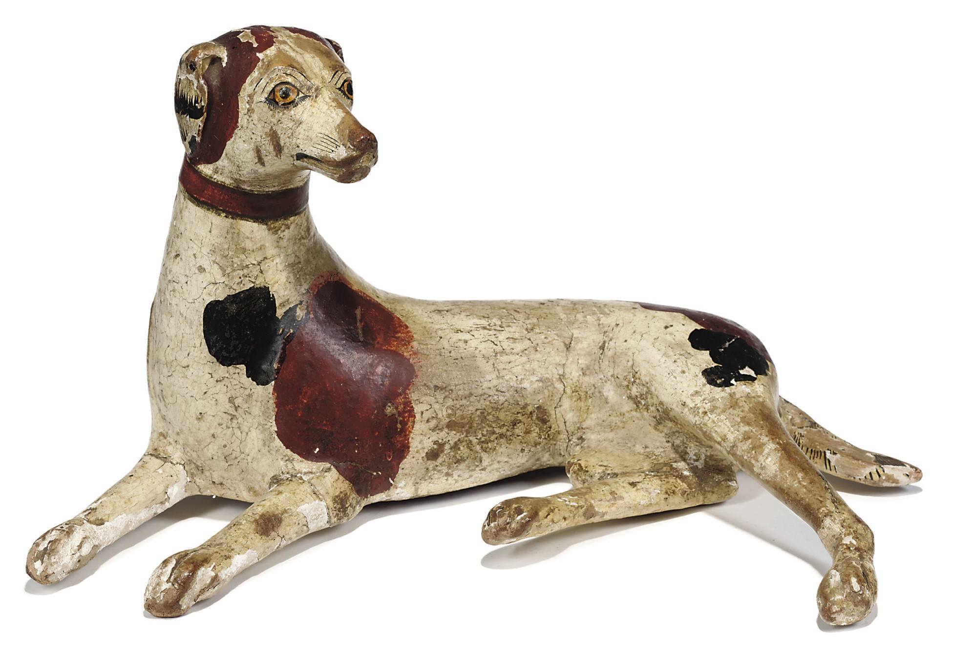 A REGENCY NATURALISTICALLY PAINTED BEECH MODEL OF A HOUND
