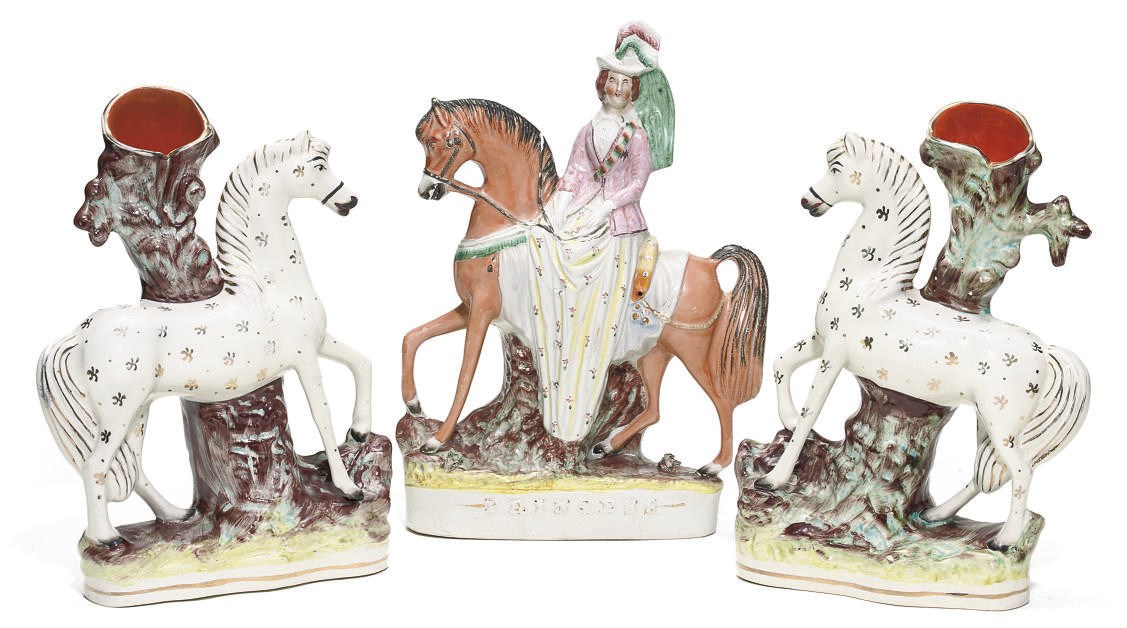 A STAFFORDSHIRE POTTERY EQUESTRIAN FIGURE AND A PAIR OF SPILL-VASES