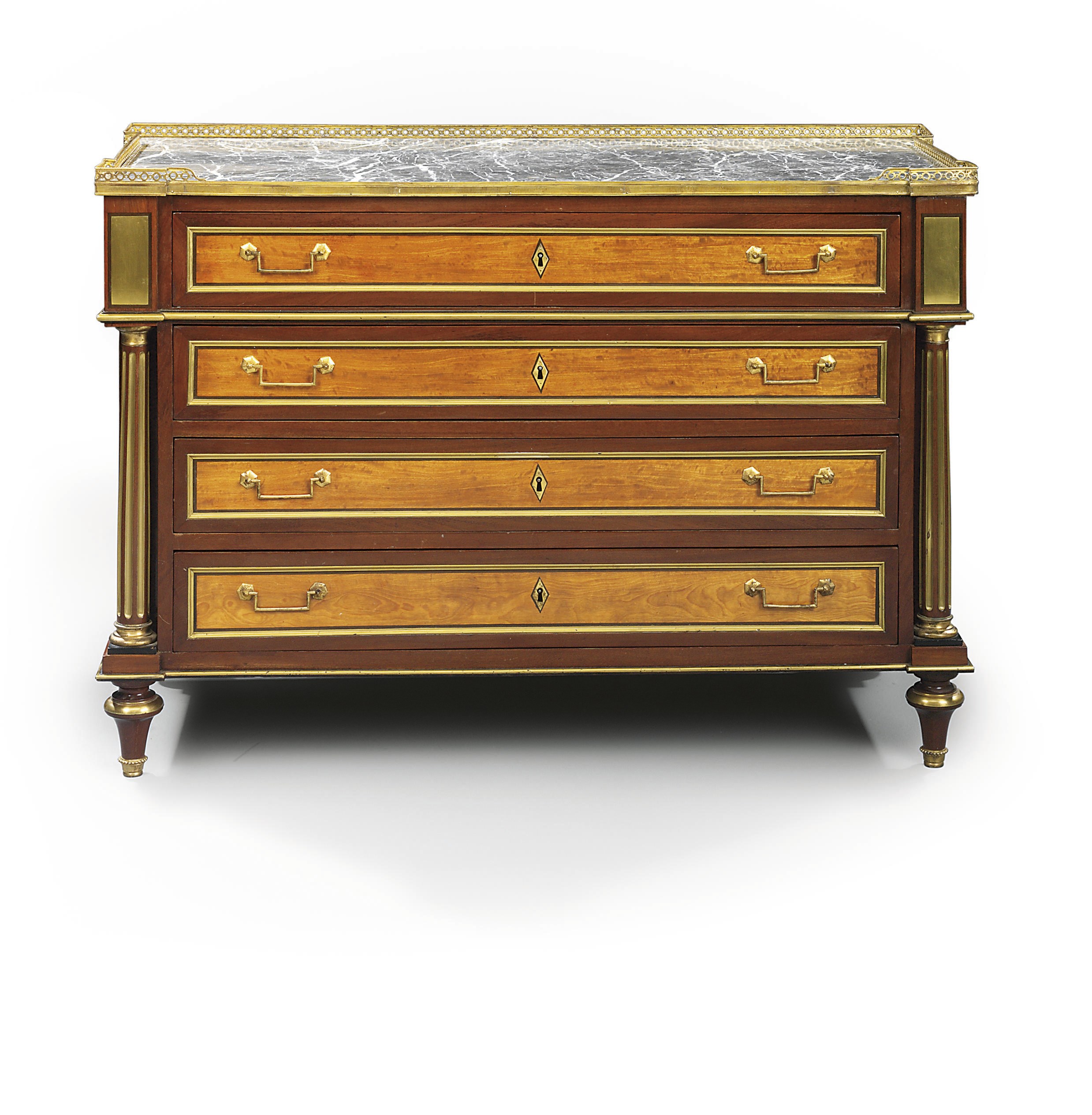A DIRECTOIRE ORMOLU-MOUNTED AND BRASS-INLAID MAHOGANY AND BOIS SATINE COMMODE