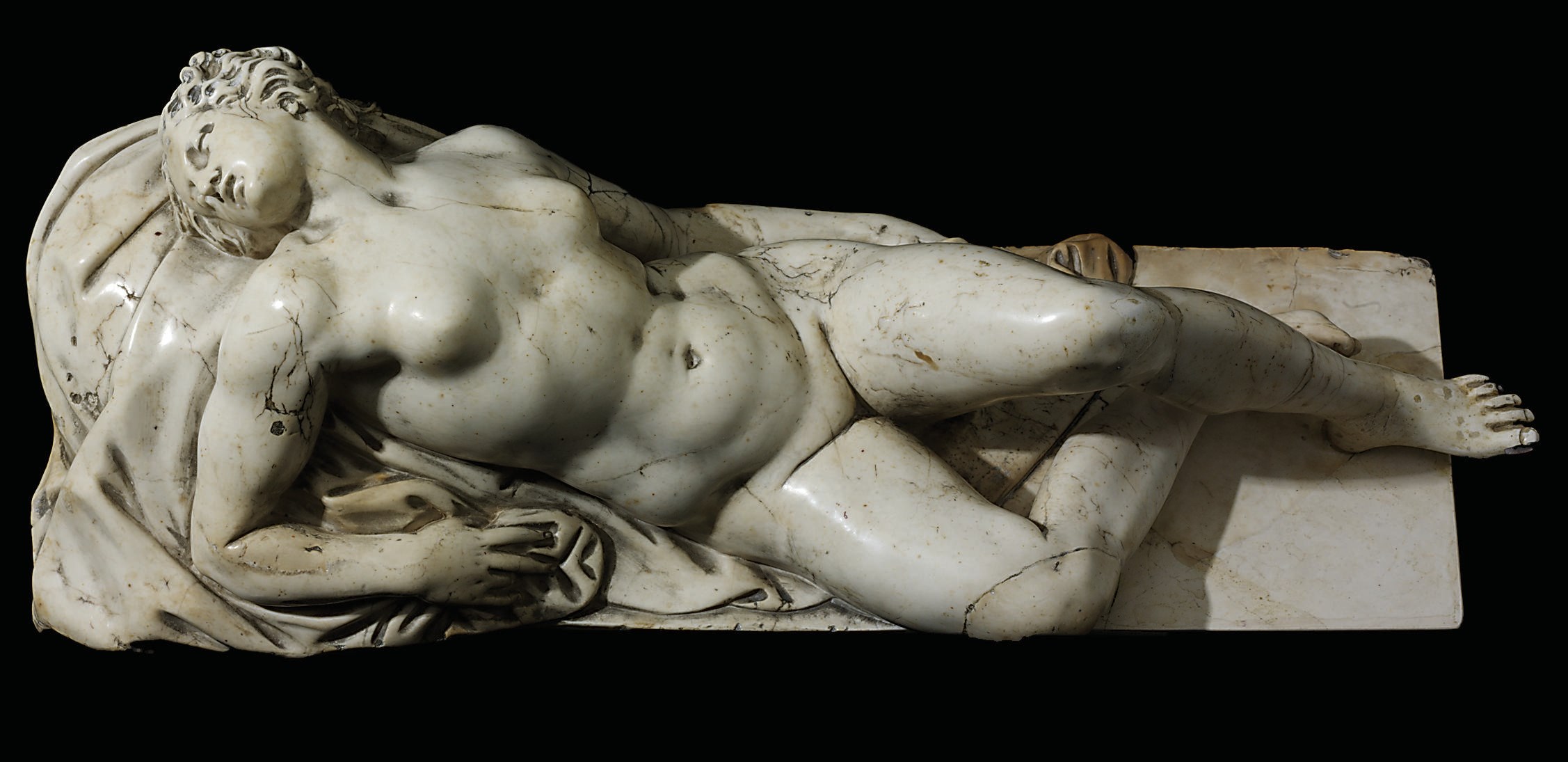 A BOTTICINO STONE FIGURE OF A SLEEPING WOMAN