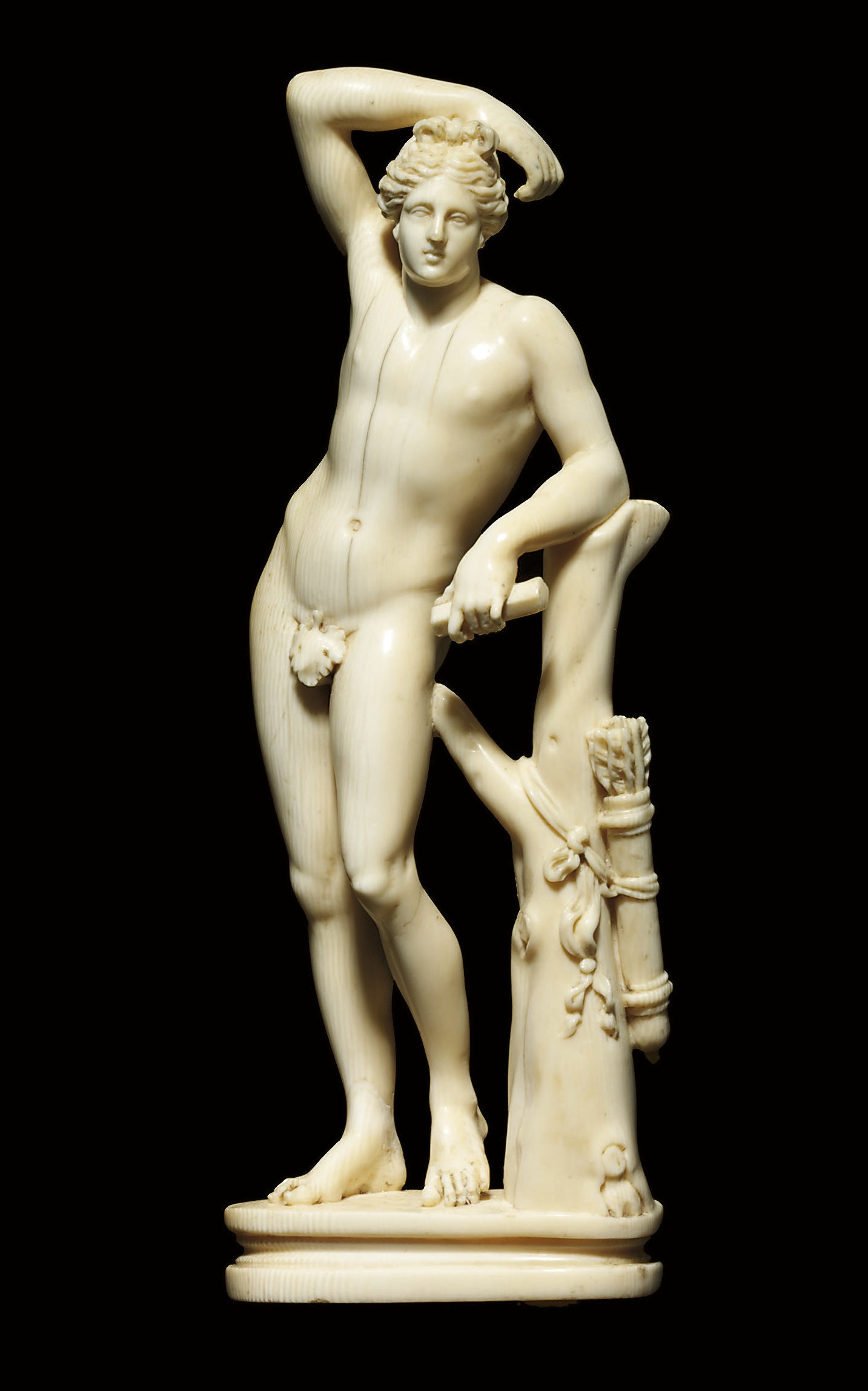 A CARVED IVORY FIGURE OF THE APOLLINO