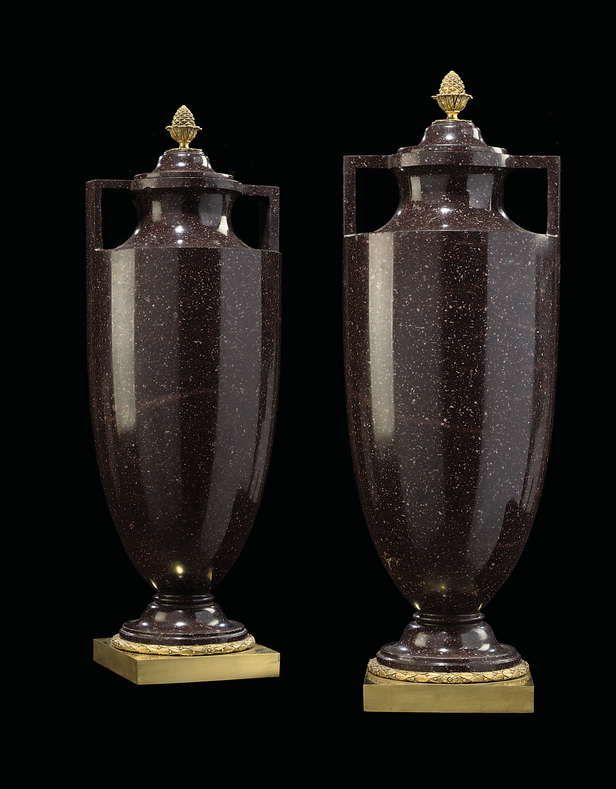 A PAIR OF ITALIAN ORMOLU-MOUNTED TWIN-HANDLED PORPHYRY URNS
