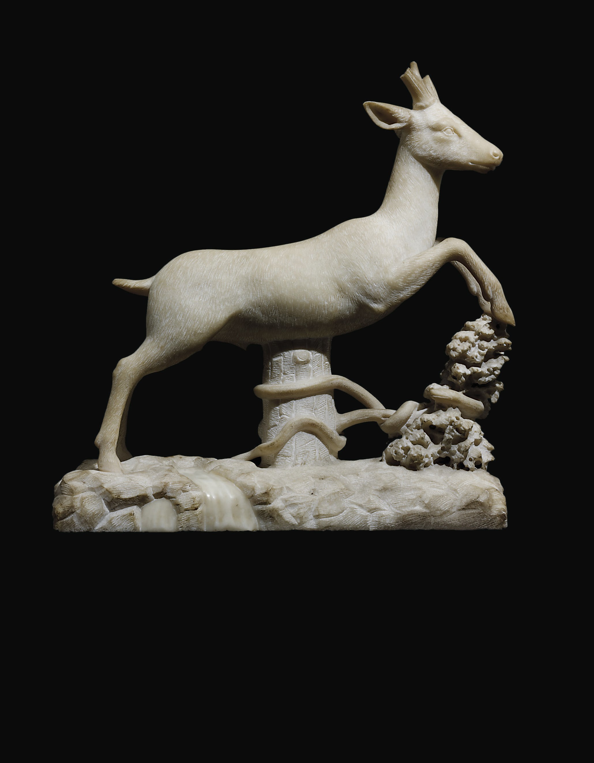 A CARVED MARBLE MODEL OF A LEAPING DEER