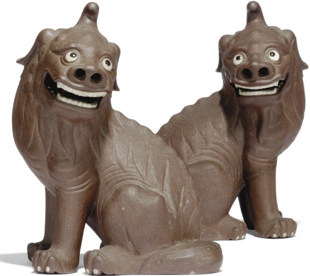 A PAIR OF CHINESE BISCUIT MODELS OF BUDDHISTIC LIONS