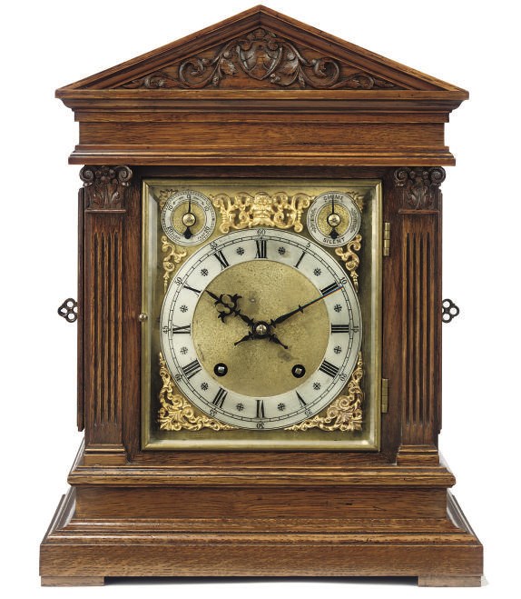 A German oak quarter striking eight day mantel clock