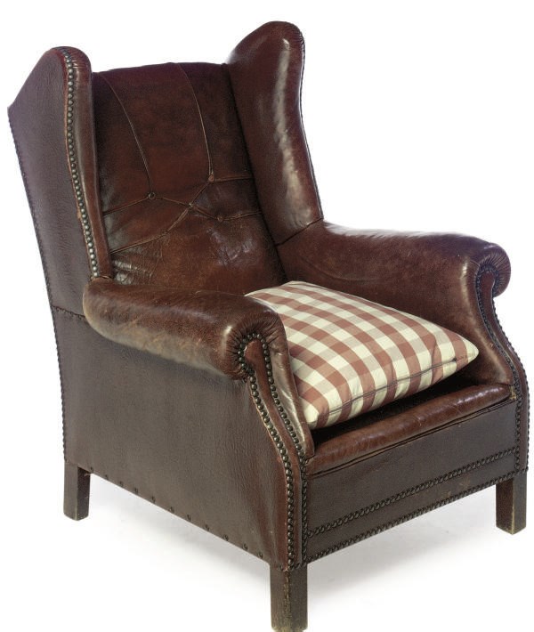 A LEATHER UPHOLSTERED WING ARMCHAIR